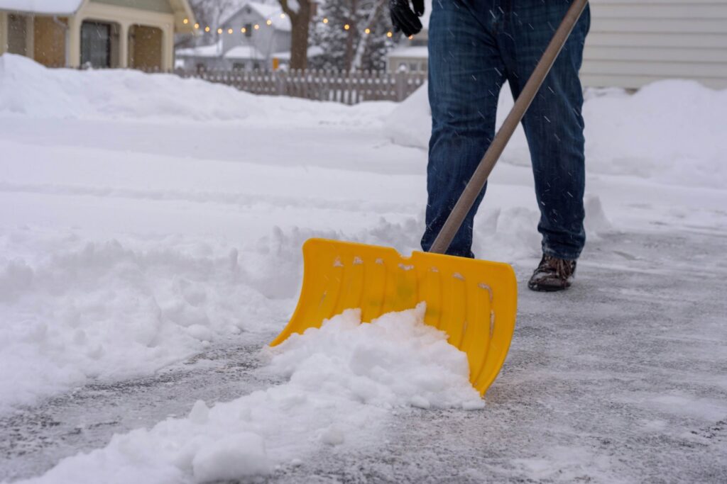 Man shoveling the driveway after winter snowstorm